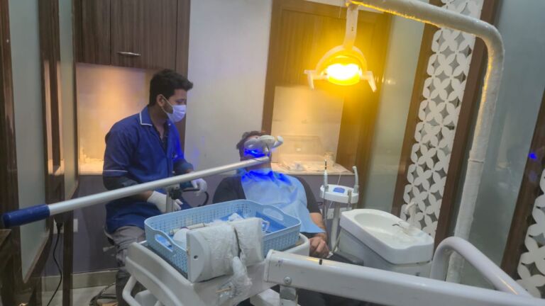 Is teeth cleaning painful? Dentist performing professional teeth cleaning and scaling treatment in a modern dental clinic.